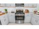 Modern kitchen showcasing stainless steel appliances, light gray cabinets, and quartz countertops at 7359 Capstone Dr, Groveland, FL 34736