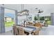 Bright and airy living room featuring dining area, neutral decor, ample natural light, and stylish furnishings at 7359 Capstone Dr, Groveland, FL 34736