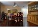 Inviting dining room with wood table, matching chairs, a large mirror, and elegant chandelier at 7508 Covedale Dr, Orlando, FL 32818