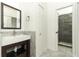 Bathroom with white sink on dark wood vanity, large mirror and modern shower at 7536 Fenwick Cove Ln, Orlando, FL 32819