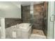 Contemporary bathroom featuring a shower with glass door and a soaking tub at 7536 Fenwick Cove Ln, Orlando, FL 32819