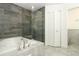 Updated bathroom with a soaking tub, glass enclosed shower, and neutral tile flooring at 7536 Fenwick Cove Ln, Orlando, FL 32819