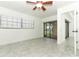Bedroom with tile flooring, ceiling fan, and sliding glass doors to screened patio at 7536 Fenwick Cove Ln, Orlando, FL 32819