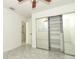 This bedroom has tile flooring and large mirrored closet doors that provide plenty of storage space at 7536 Fenwick Cove Ln, Orlando, FL 32819