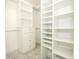 Walk-in closet featuring custom shelving, drawers, and ample storage space at 7536 Fenwick Cove Ln, Orlando, FL 32819