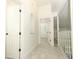 Hallway with neutral tile flooring and white walls at 7536 Fenwick Cove Ln, Orlando, FL 32819