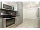 Modern kitchen featuring stainless steel appliances, gray cabinets, and durable countertops, perfect for cooking and entertaining at 7536 Fenwick Cove Ln, Orlando, FL 32819