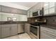 Updated kitchen with stainless steel appliances, ample cabinet space, and a pass-through to the dining area at 7536 Fenwick Cove Ln, Orlando, FL 32819