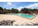 Large community pool with lounge chairs and umbrellas for relaxation at 7536 Fenwick Cove Ln, Orlando, FL 32819
