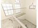 Bright staircase with white railings and neutral tile floors, filled with light at 7536 Fenwick Cove Ln, Orlando, FL 32819