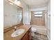 Inviting bathroom featuring wood vanity, framed mirror, and shower-tub combination at 759 Dromedary Dr, Kissimmee, FL 34759