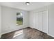 Bedroom featuring wood-look flooring, a closet, and a window to the backyard at 759 Dromedary Dr, Kissimmee, FL 34759