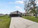 Charming single-story home with a large driveway and a well-manicured lawn at 759 Dromedary Dr, Kissimmee, FL 34759