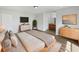 Serene main bedroom featuring hardwood floors, ensuite bath, and contemporary furnishings at 759 Dromedary Dr, Kissimmee, FL 34759