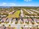 Aerial view of home featuring the adjacent green space, nearby lake, and community setting at 7916 Wandering Way, Orlando, FL 32836