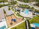 Aerial scene highlights a community pool area with playground, promising recreational options for families at 7916 Wandering Way, Orlando, FL 32836