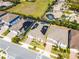 Aerial perspective showcases roof-mounted solar panels, a refreshing screened-in pool, and lush surroundings at 7916 Wandering Way, Orlando, FL 32836