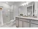 Modern bathroom featuring a glass-enclosed shower and granite countertops at 7916 Wandering Way, Orlando, FL 32836