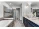 Bathroom features double sinks, granite countertops, and a walk-in shower next to a soaking tub at 7916 Wandering Way, Orlando, FL 32836