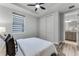 This bedroom is stylish with neutral colors, a ceiling fan and a view of the bathroom at 7916 Wandering Way, Orlando, FL 32836