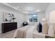 Inviting bedroom is furnished with wood accents, neutral bedding, and features a large sunlit window at 7916 Wandering Way, Orlando, FL 32836