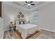 Comfortable bedroom with a ceiling fan, woven rug and decorative wall art at 7916 Wandering Way, Orlando, FL 32836
