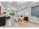 Well-lit primary bedroom features a tray ceiling, wood floors, and ample natural light through a large window at 7916 Wandering Way, Orlando, FL 32836