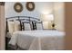 Well-lit main bedroom with a black metal headboard and decorated with plants at 7916 Wandering Way, Orlando, FL 32836