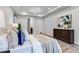Cozy bedroom with a decorative tray ceiling, dark wood furniture, and soothing neutral tones at 7916 Wandering Way, Orlando, FL 32836