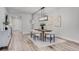 Contemporary dining room featuring modern lighting, stylish furnishings, and wood-look flooring at 7916 Wandering Way, Orlando, FL 32836