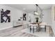 Bright dining area featuring sleek wood flooring, modern decor and a stylish light fixture at 7916 Wandering Way, Orlando, FL 32836