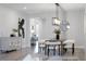 Open dining area with modern lighting, stylish furniture, and a view into adjacent rooms at 7916 Wandering Way, Orlando, FL 32836