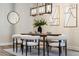 Bright dining area showcasing a modern light fixture, stylish decor, and wood-look floors at 7916 Wandering Way, Orlando, FL 32836
