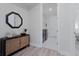 Elegant entryway featuring decorative cabinet with a mirror and a peek into the laundry room at 7916 Wandering Way, Orlando, FL 32836