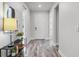 Inviting entryway featuring sleek wood-look flooring and a view into other rooms in the house at 7916 Wandering Way, Orlando, FL 32836