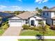 Charming single-story home featuring a well-manicured lawn and a two car garage in a sunny neighborhood at 7916 Wandering Way, Orlando, FL 32836