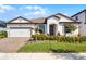 Charming single-story home with a well-manicured lawn and a two-car garage at 7916 Wandering Way, Orlando, FL 32836