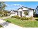 Beautiful single-story home with manicured lawn and a brick driveway, showcasing curb appeal at 7916 Wandering Way, Orlando, FL 32836