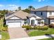 Attractive single-story home with well-maintained landscaping, brick driveway and solar panels at 7916 Wandering Way, Orlando, FL 32836