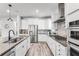 Well-equipped kitchen with stainless steel appliances, granite countertops, and wood flooring at 7916 Wandering Way, Orlando, FL 32836