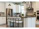 Bright kitchen with stainless steel appliances, white cabinets, tiled backsplash and island with seating at 7916 Wandering Way, Orlando, FL 32836
