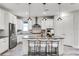 Modern kitchen with stainless steel appliances, granite countertops, and a center island with bar seating at 7916 Wandering Way, Orlando, FL 32836