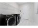 Modern laundry room with front loading washer and dryer at 7916 Wandering Way, Orlando, FL 32836