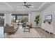Bright living room with tray ceiling, ceiling fan, and sliding glass doors to the outdoor living space at 7916 Wandering Way, Orlando, FL 32836
