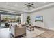 Living room with hardwood floors, modern decor, and views of the outdoor pool area at 7916 Wandering Way, Orlando, FL 32836