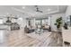 Open-concept living room with hardwood floors, modern decor, and sliding glass doors to the outside at 7916 Wandering Way, Orlando, FL 32836