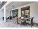 Charming covered patio with a dining table and chairs, perfect for outdoor entertaining at 7916 Wandering Way, Orlando, FL 32836