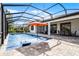 Spacious screened-in pool area with lounge chairs, umbrella and outdoor seating at 7916 Wandering Way, Orlando, FL 32836