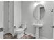 Chic powder room with a pedestal sink and designer fixtures at 7916 Wandering Way, Orlando, FL 32836