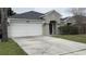 Charming single-Gathering home features a two-car garage, well-maintained landscaping, and a welcoming front entrance at 8419 Fort Thomas Way, Orlando, FL 32822